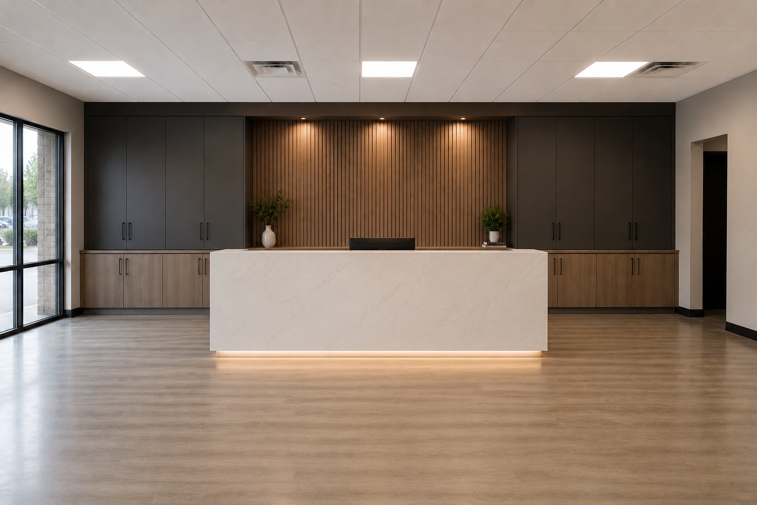 After view of Edmonton commercial reception millwork with custom cabinetry and warm lighting