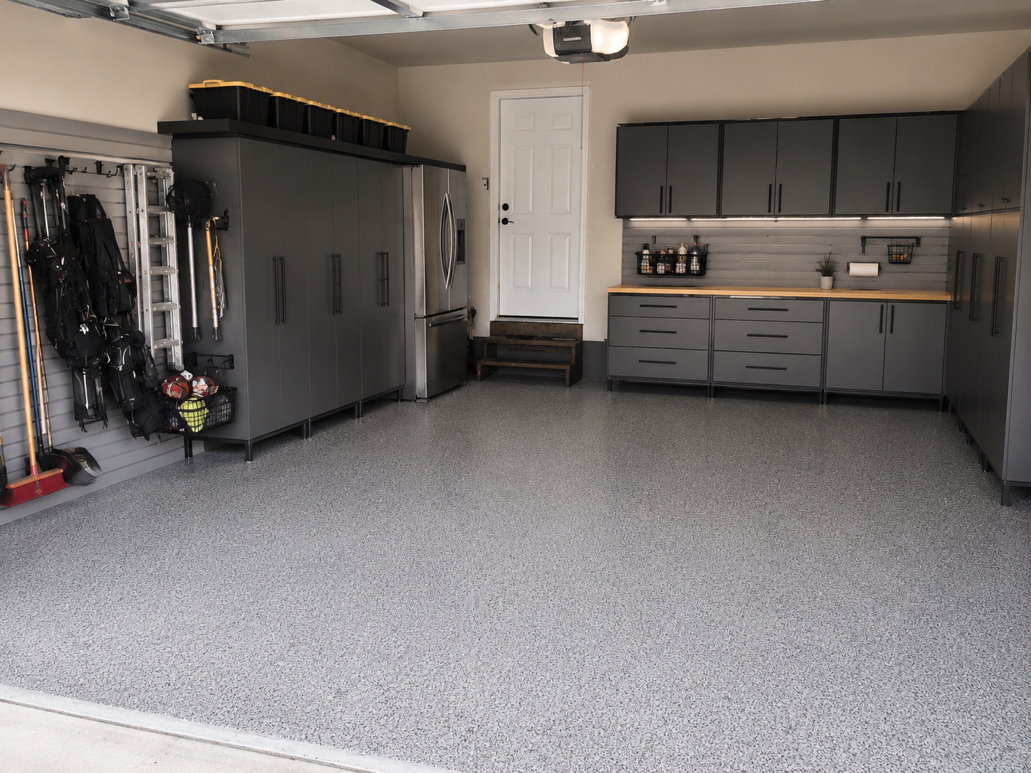 After view of Edmonton garage with custom grey storage cabinets and organized tool wall