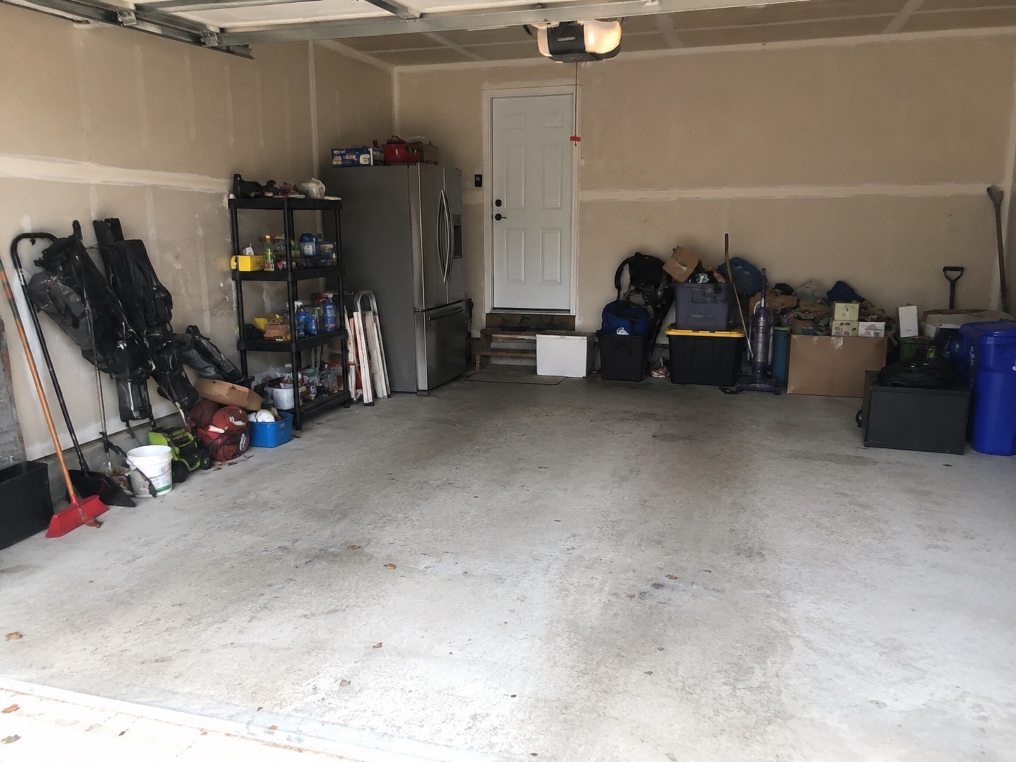 Before view of an unfinished Edmonton garage wall before custom storage cabinets